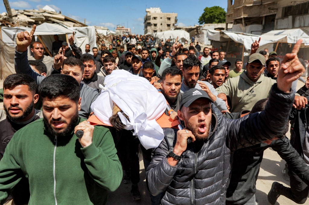 Mourners carry the body of Azzam Khalil al-Hayya, son of the deputy chairman of Hamas' Political Bureau Khalil al-Hayya, after the former was killed the previous day by Israeli bombardment, during the